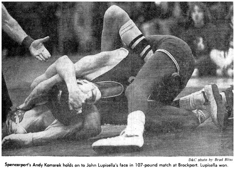 Spencerport\'s Andy Komarek holds on to John Lupisella\'s face